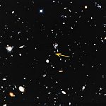 Small portion of Hubble Deep Field image, with arrow pointing to a very distant galaxy.